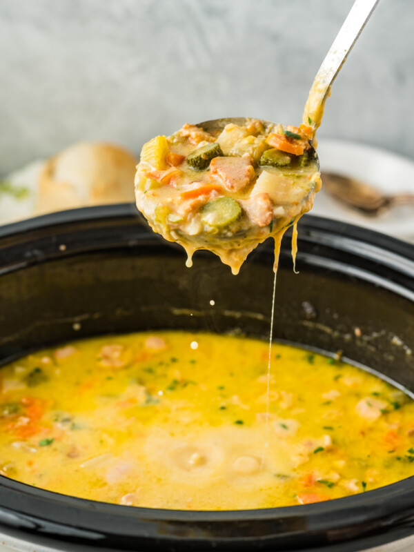 Dill pickle soup on a ladle.