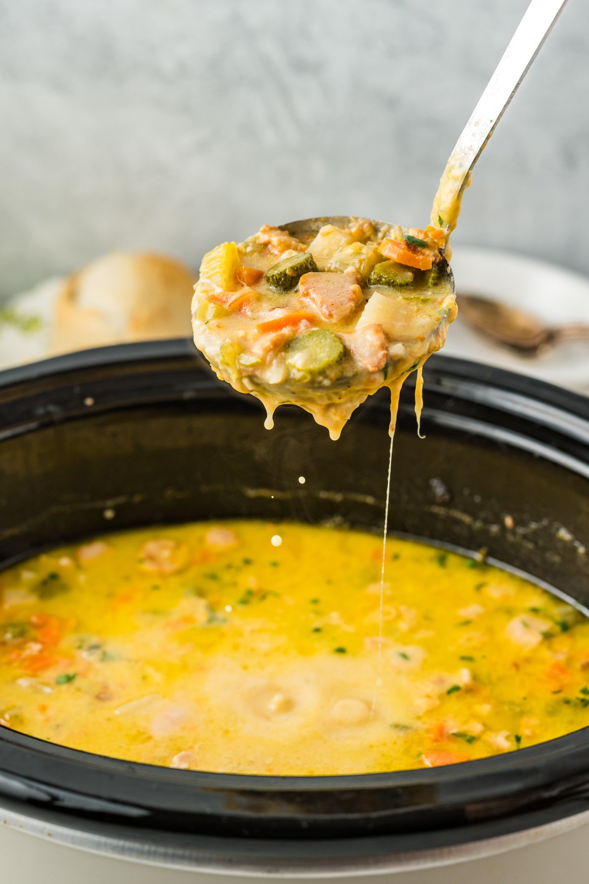 Dill pickle soup on a ladle.