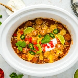 overhead of enchilada meatballs in a slow cooker.