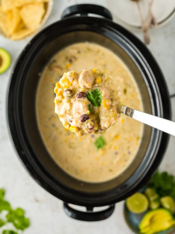 ladle of slow cooker green enchilada soup.