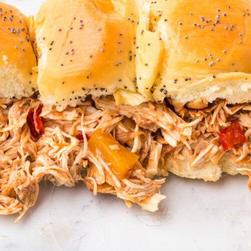 slow cooker hawaiian sliders on a marble surface.