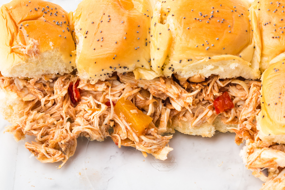 slow cooker hawaiian sliders on a marble surface.