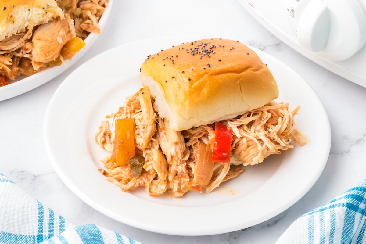 one of the slow cooker hawaiian sliders on a white plate.