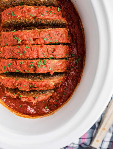 overhead of sliced Italian meatloaf in a slow cooker.
