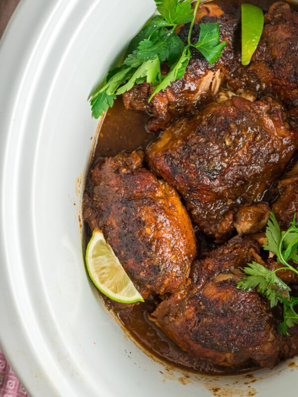 overhead of Jamaican jerk chicken in a slow cooker.