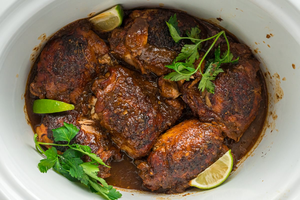 overhead of crockpot Jamaican jerk chicken.