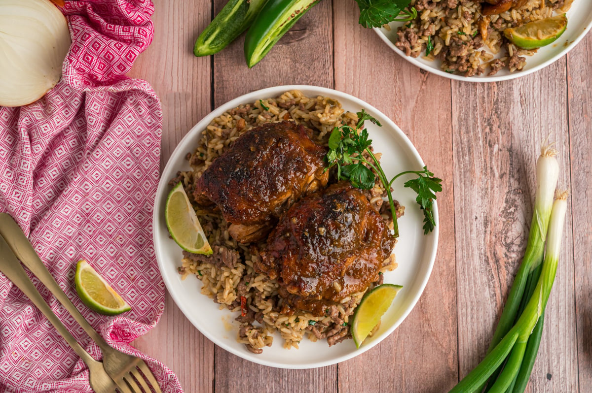 overhead shot of serving of slow cooker jamaican jerk chicken with rice on a plate.