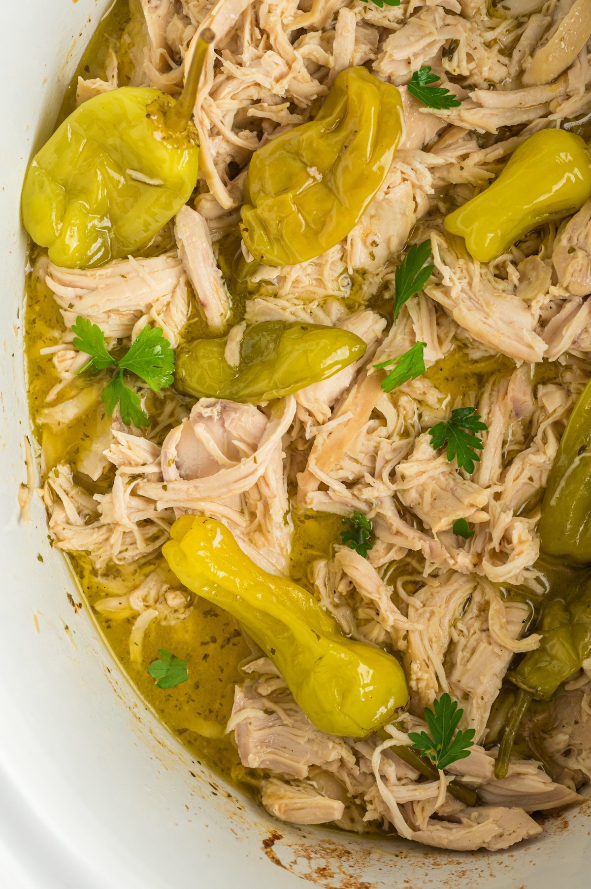 close-up overhead of mississippi chicken in a slow cooker.