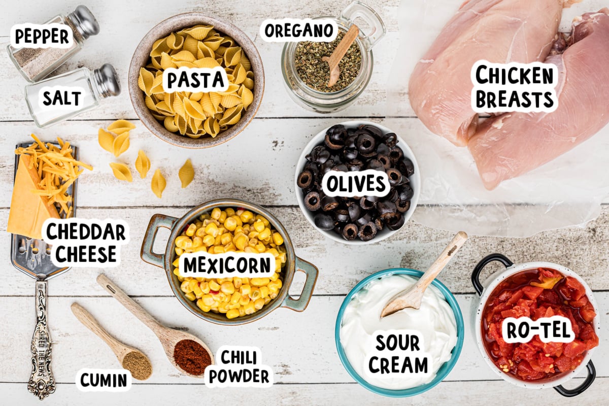 ingredients for slow cooker southwestern cheesy chicken pasta on a table.