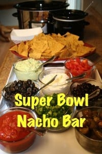 everything you need for a nacho bar in front of 2 crockpots.