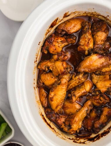 overhead of bbq chicken wings in a slow cooker.