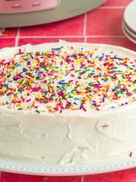 slow cooker birthday cake on a white plate.