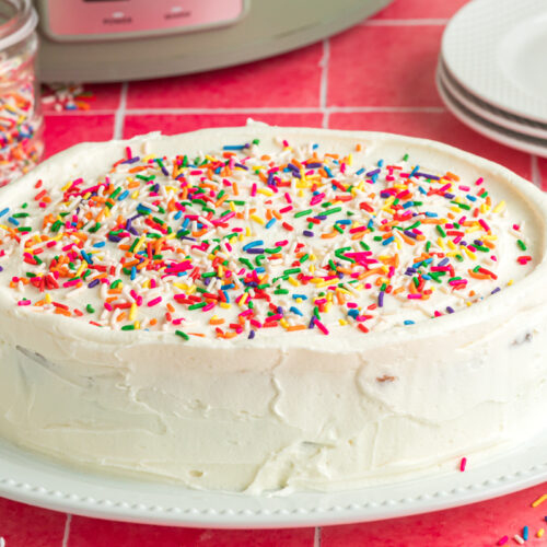 slow cooker birthday cake on a white plate.