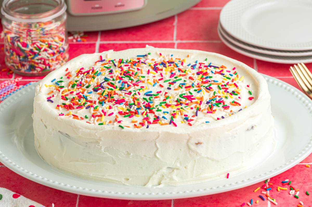 slow cooker birthday cake on a white plate.