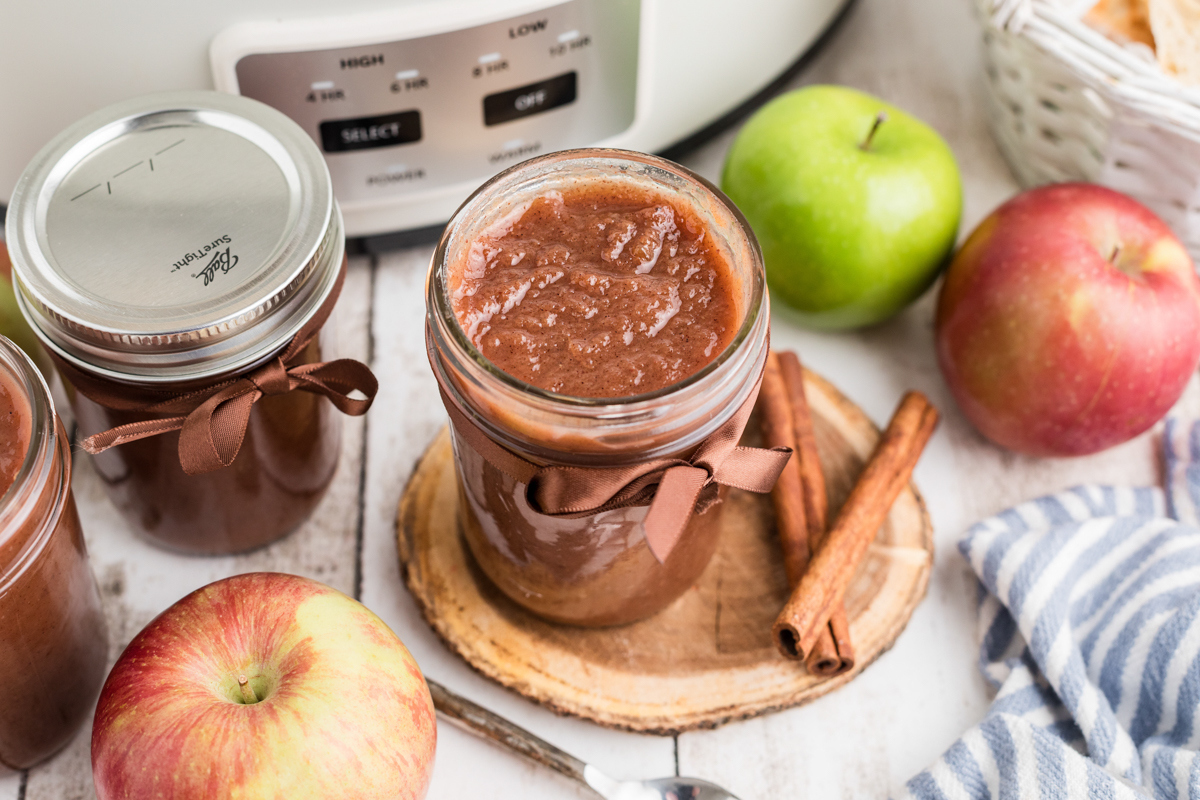 slow cooker caramel apple butter in a mason jar. 