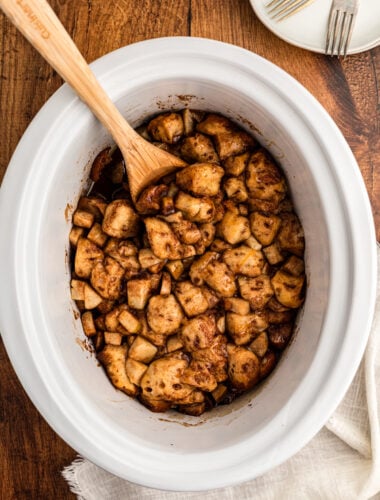 overhead of caramel apple cinnamon roll casserole in a slow cooker.