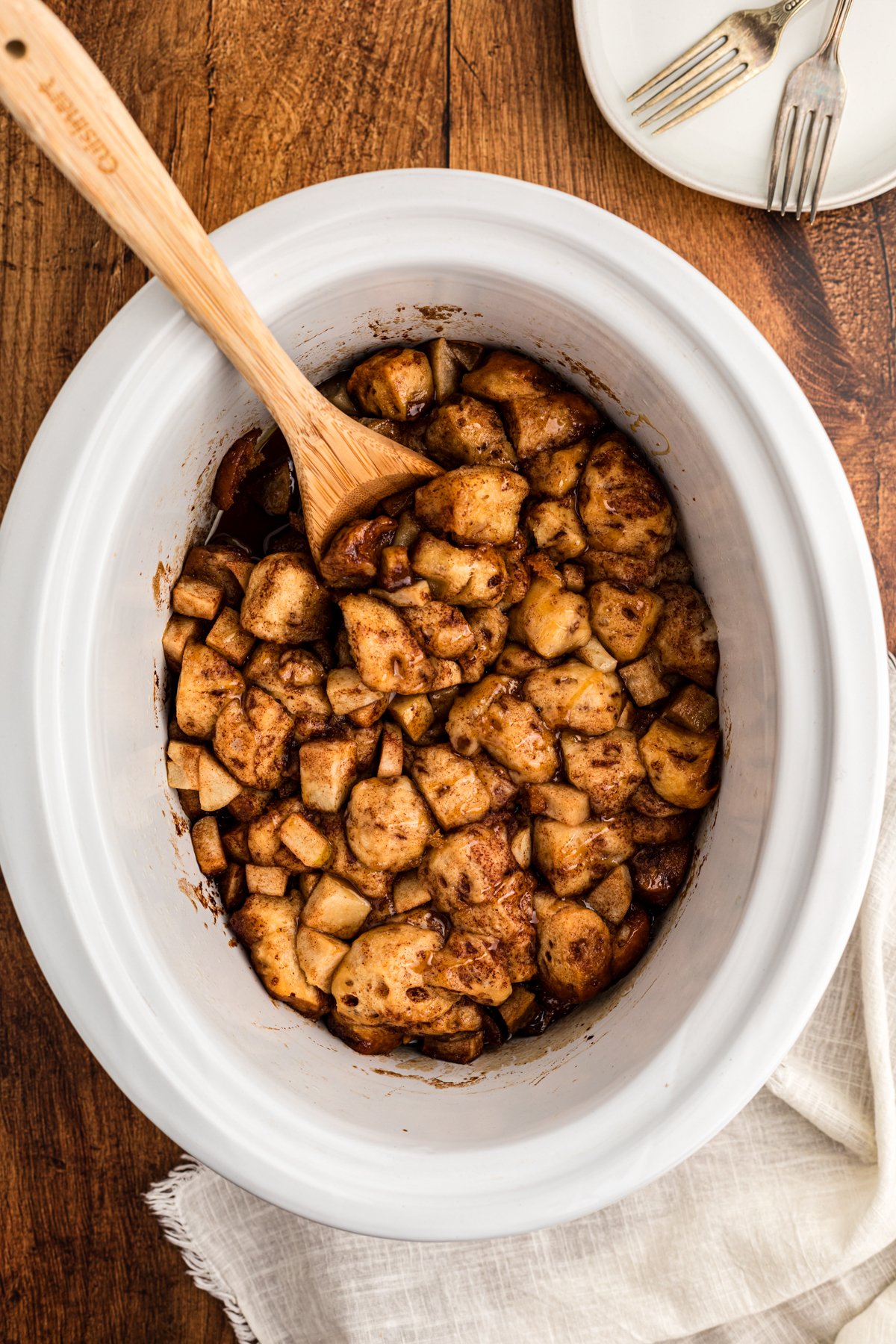 overhead of caramel apple cinnamon roll casserole in a slow cooker.