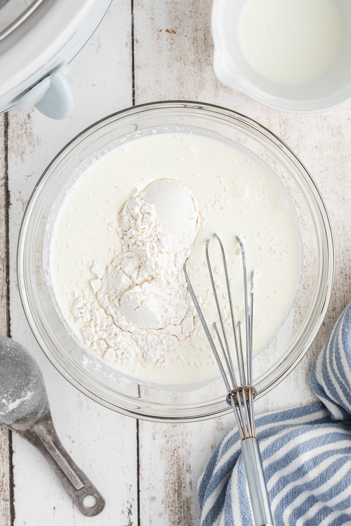 heavy cream and flour in a bowl being stirring together.