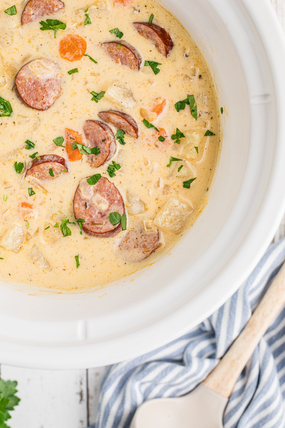 overhead of slow cooker cheesy kielbasa soup.