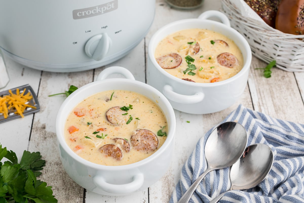 two bowls of slow cooker cheesy kielbasa soup.