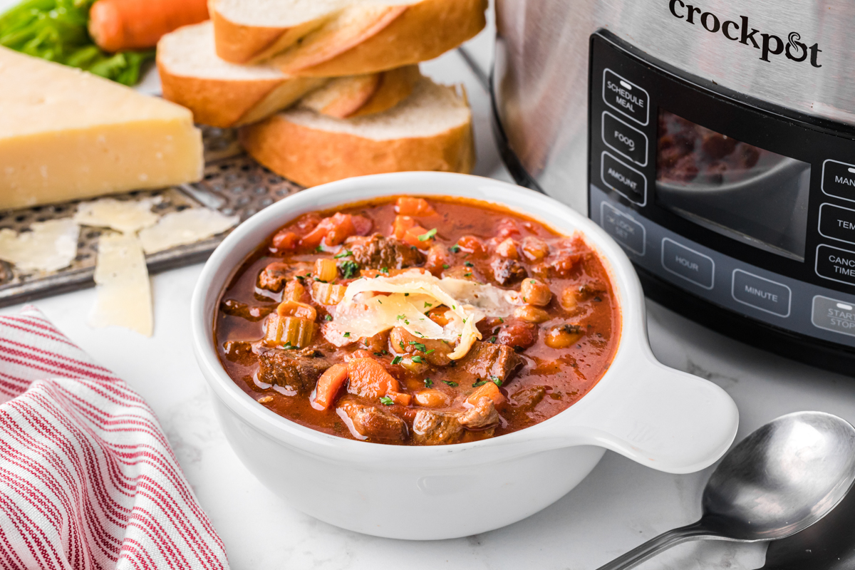 serving of slow cooker hearty italian beef soup in a bowl.