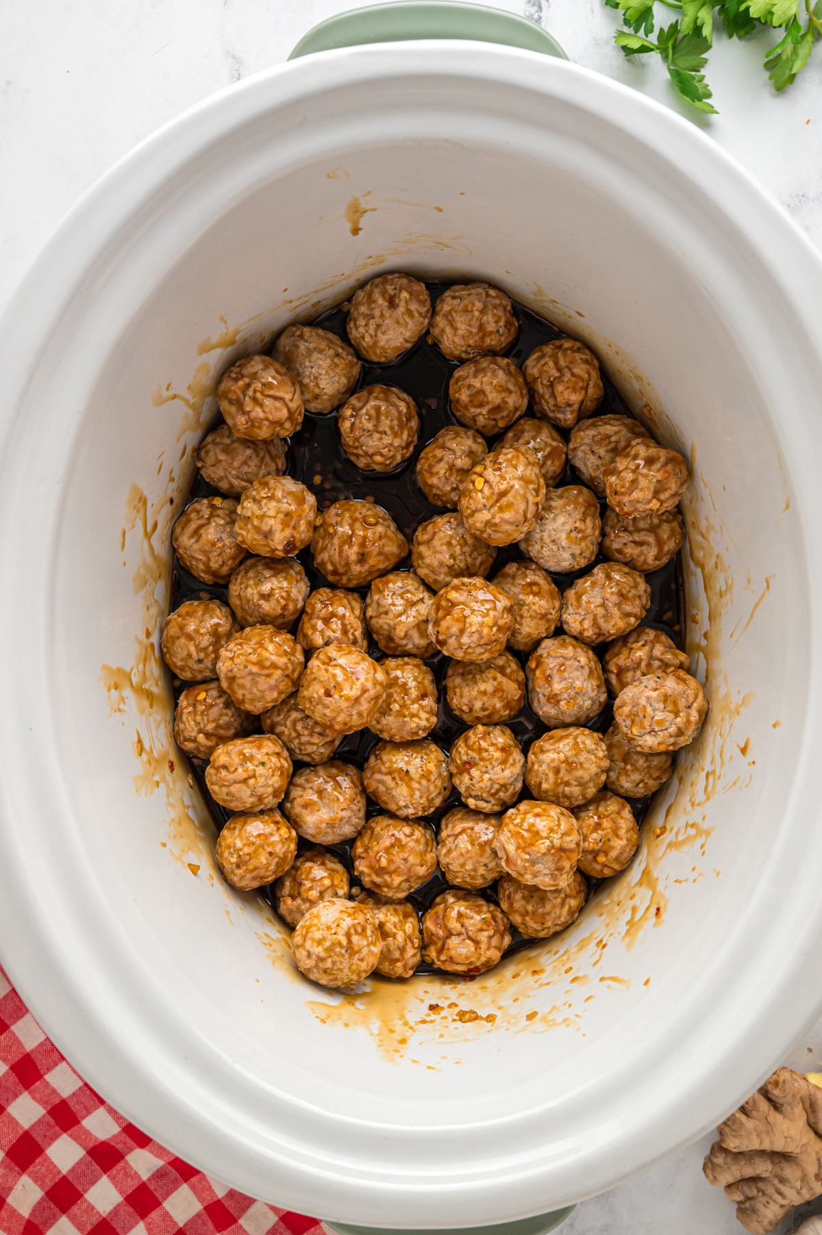 Frozen meatballs and honey garlic sauce in a crockpot.