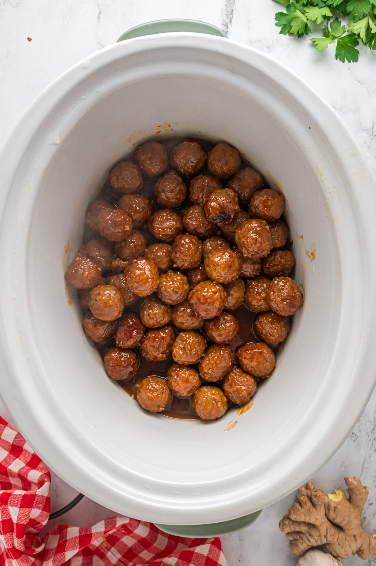 Cooked honey garlic meatballs in a slow cooker.