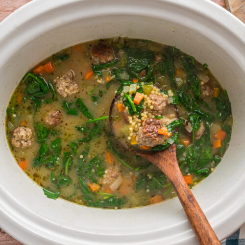 overhead of italian wedding soup in a slow cooker.