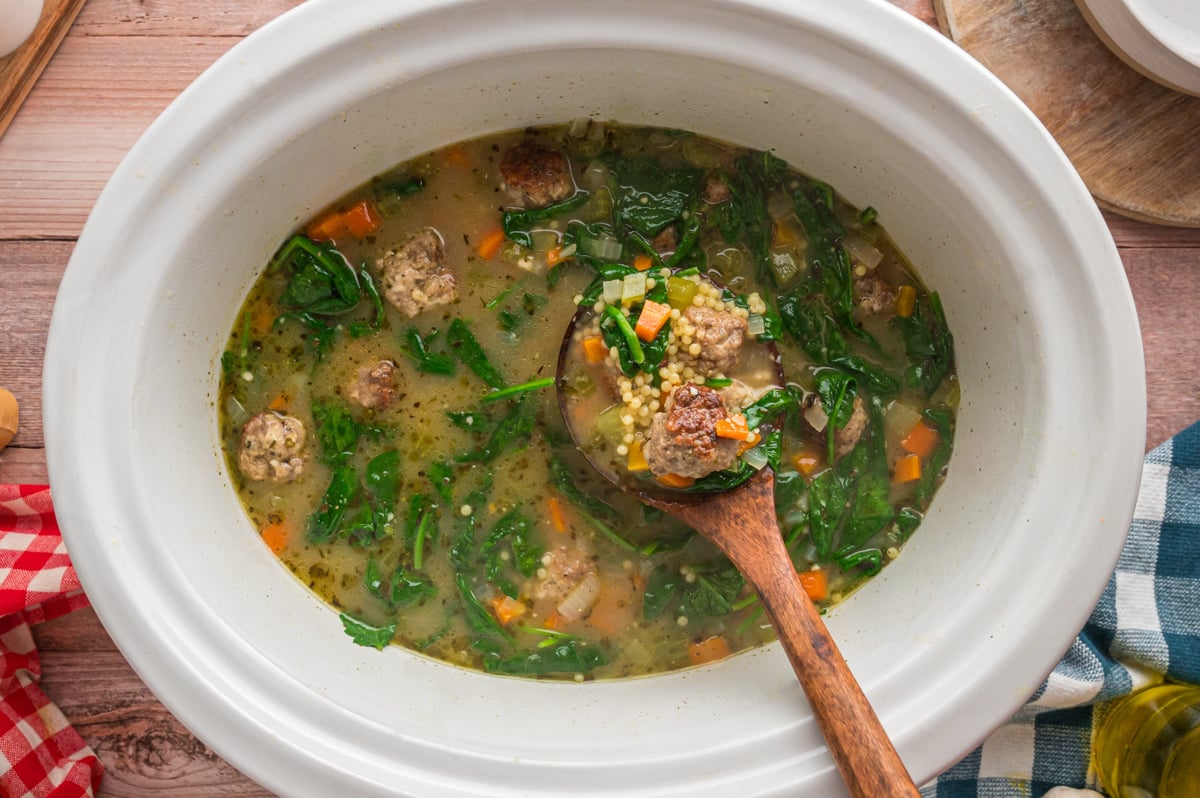 overhead of italian wedding soup in a slow cooker.