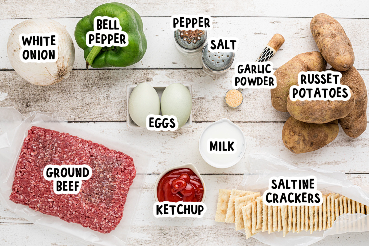 ingredients for slow cooker meatloaf and baked potatoes on a table.