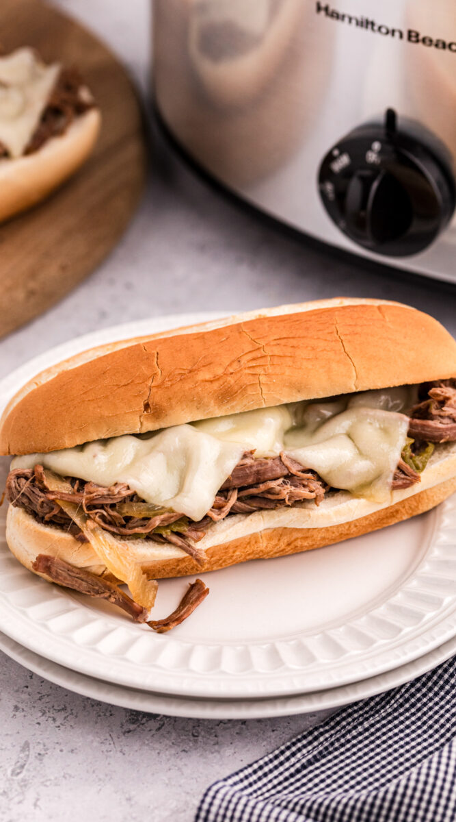 long image of slow cooker philly cheese steak sandwich.