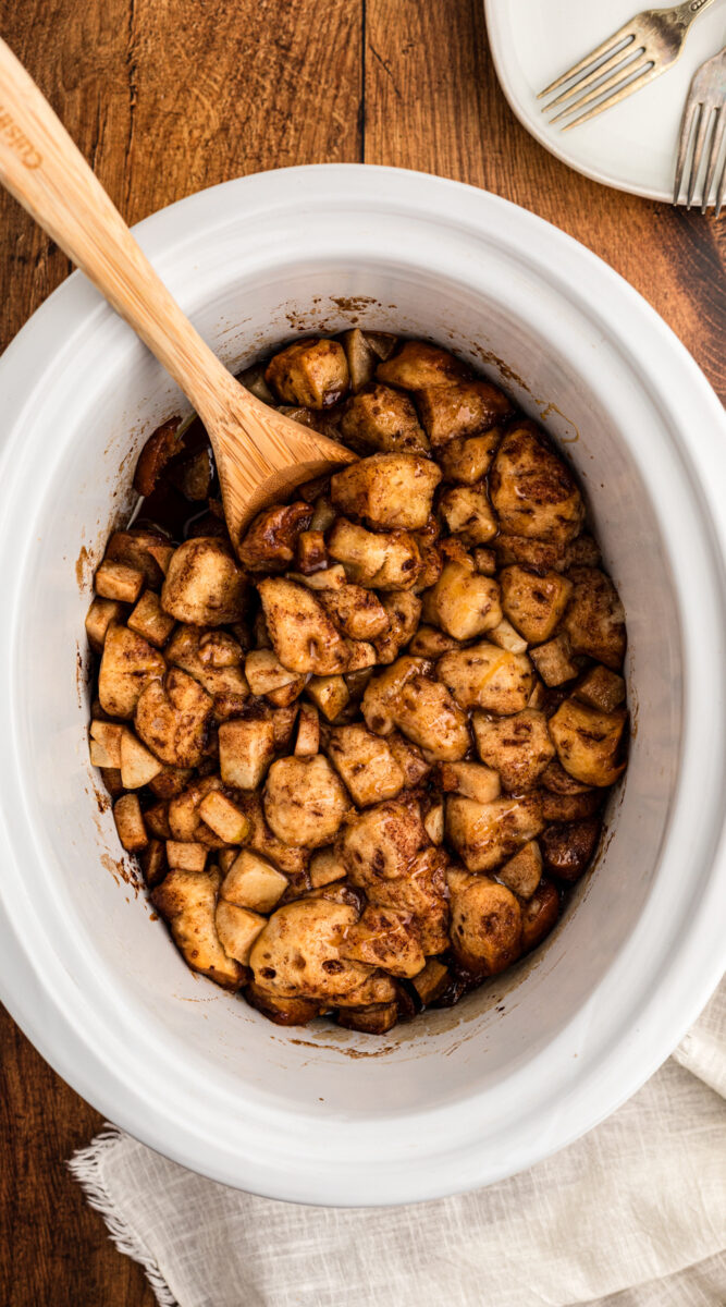 long image of slow cooker caramel apple cinnamon roll casserole.