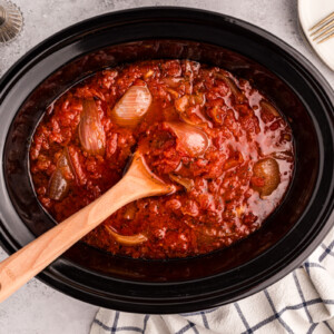 overhead shot of tomato butter sauce in a slow cooker.