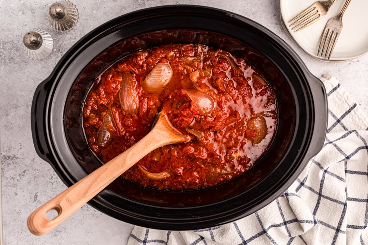 overhead shot of tomato butter sauce in a slow cooker.