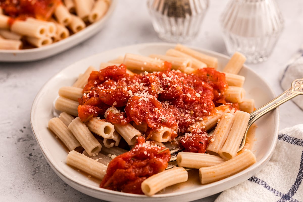 pasta topped with slow cooker tomato butter sauce on a plate. 