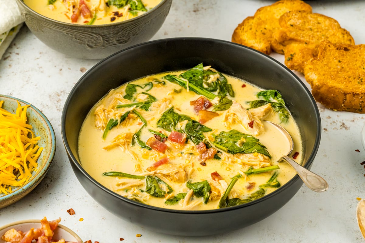 slow cooker crack chicken soup in a bowl with a spoon.