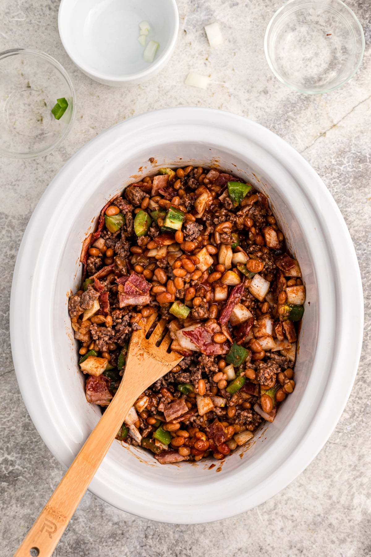 uncooked baked beans in the slow cooker, stirred together.