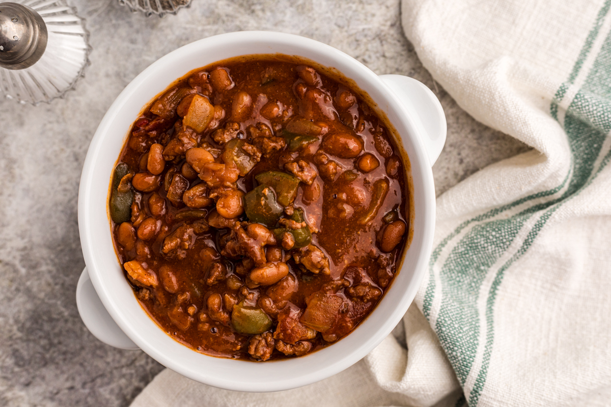 overhead of serving of slow cooker land your man baked beans in a bowl.