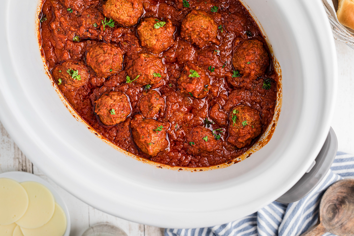 overhead shot of meatballs cooking for slow cooker meatball sliders.