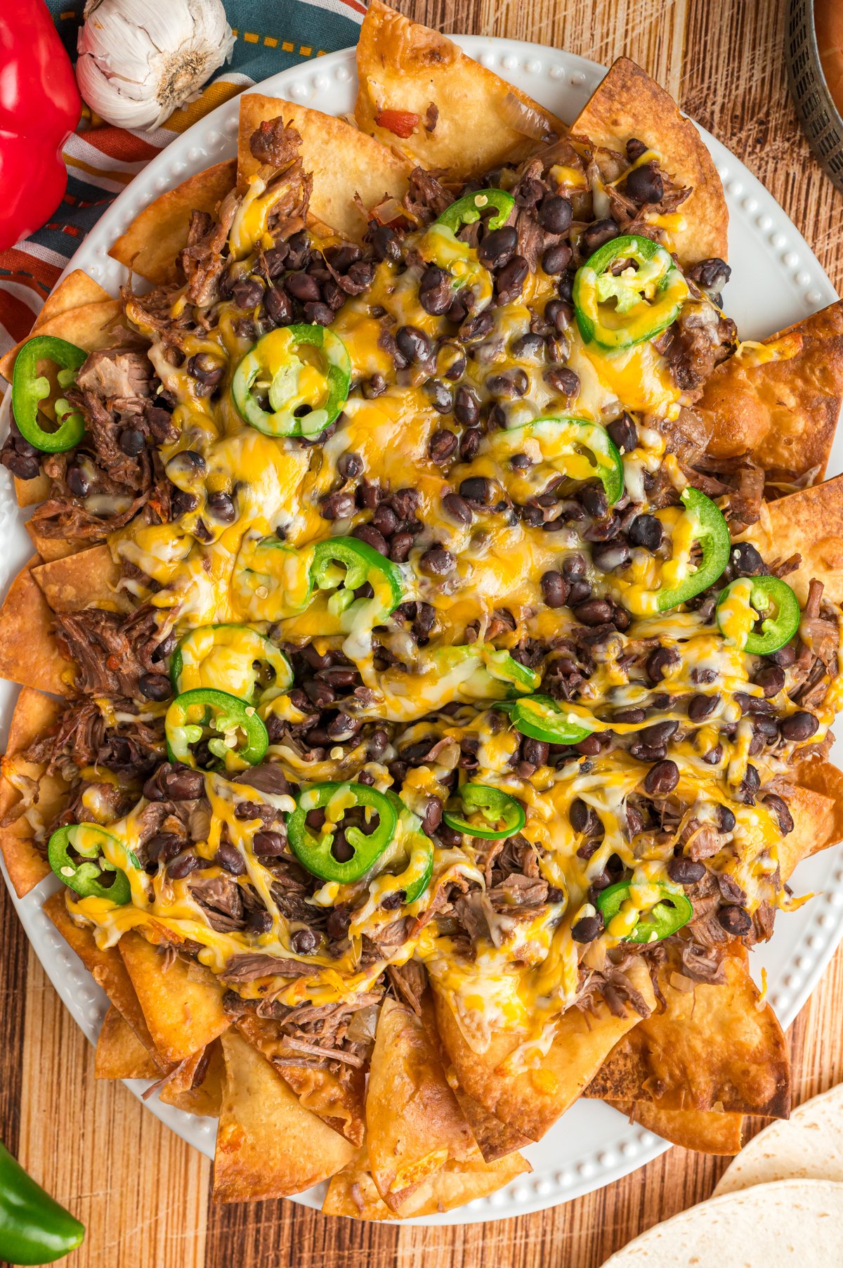 overhead shot of slow cooker pot roast nachos on a serving platter.