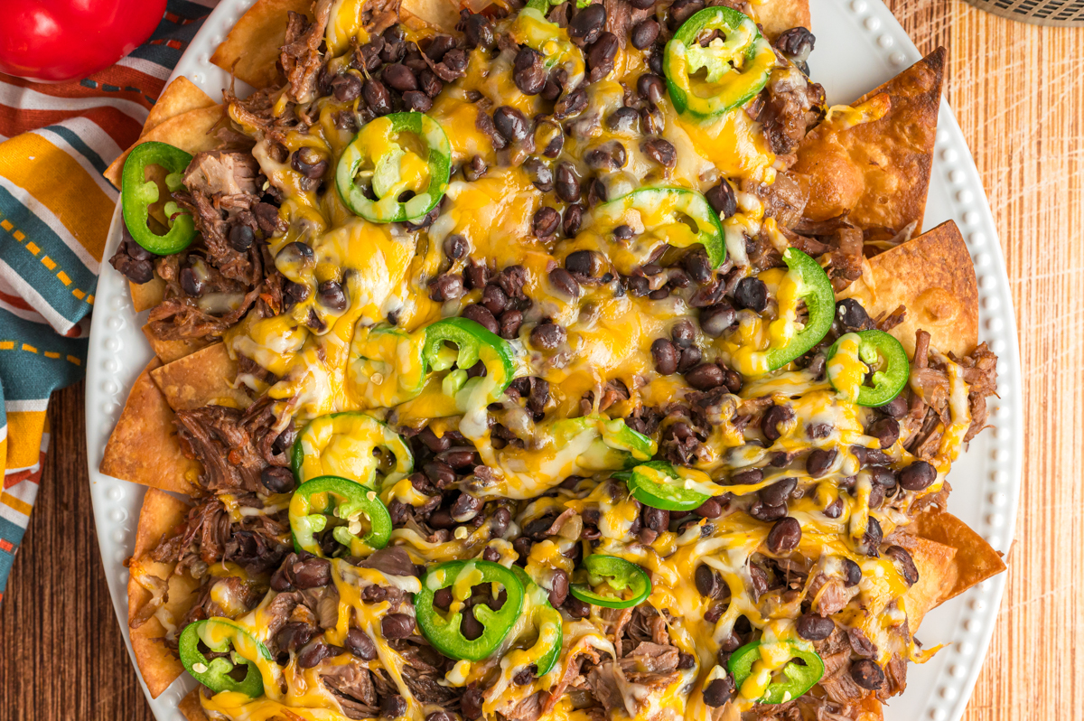 overhead of slow cooker pot roast nachos.