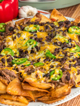slow cooker pot roast nachos on a serving platter.
