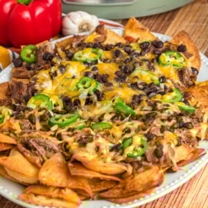 slow cooker pot roast nachos on a serving platter.