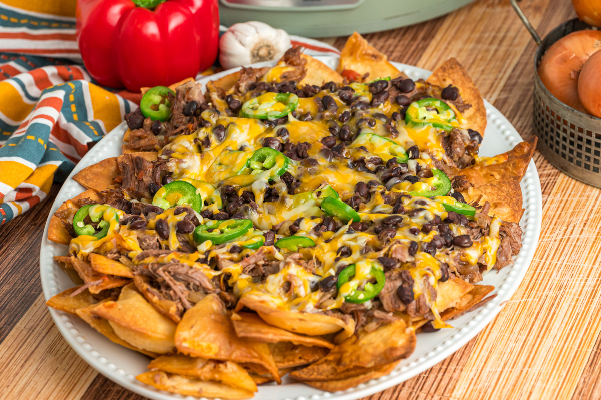 slow cooker pot roast nachos on a serving platter.