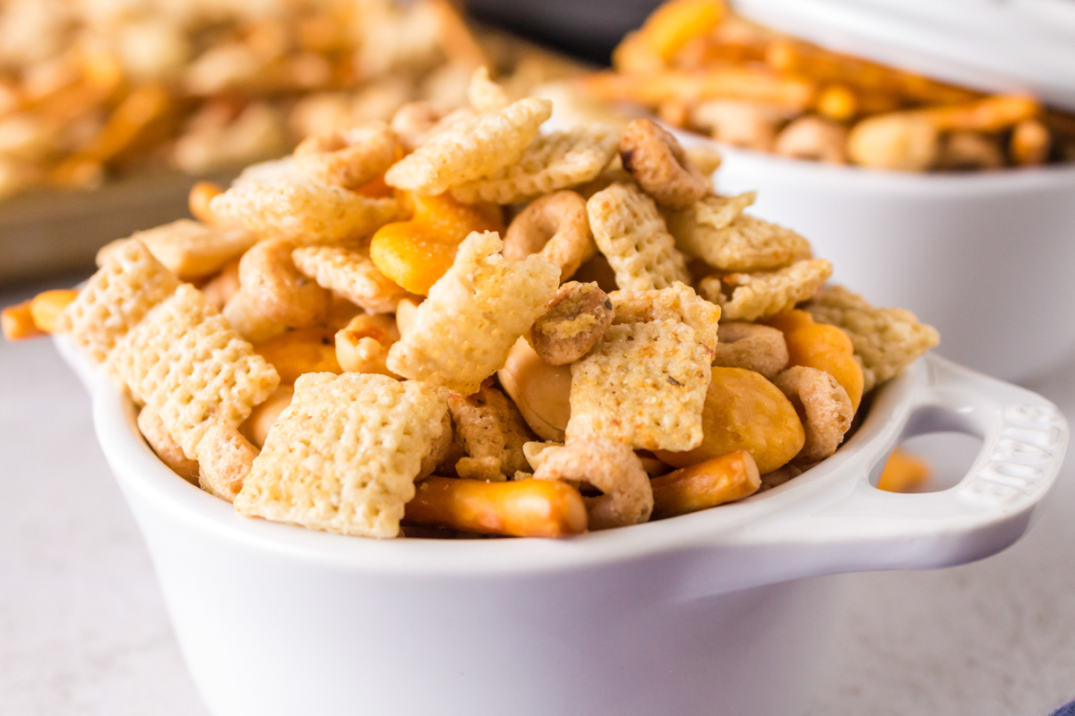 close-up of slow cooker ranch chex mix in a white dish.