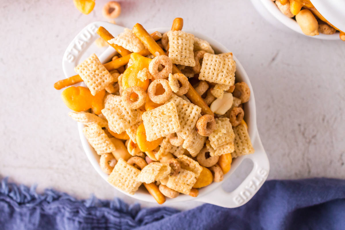 overhead shot of slow cooker ranch chex mix in a white dish.