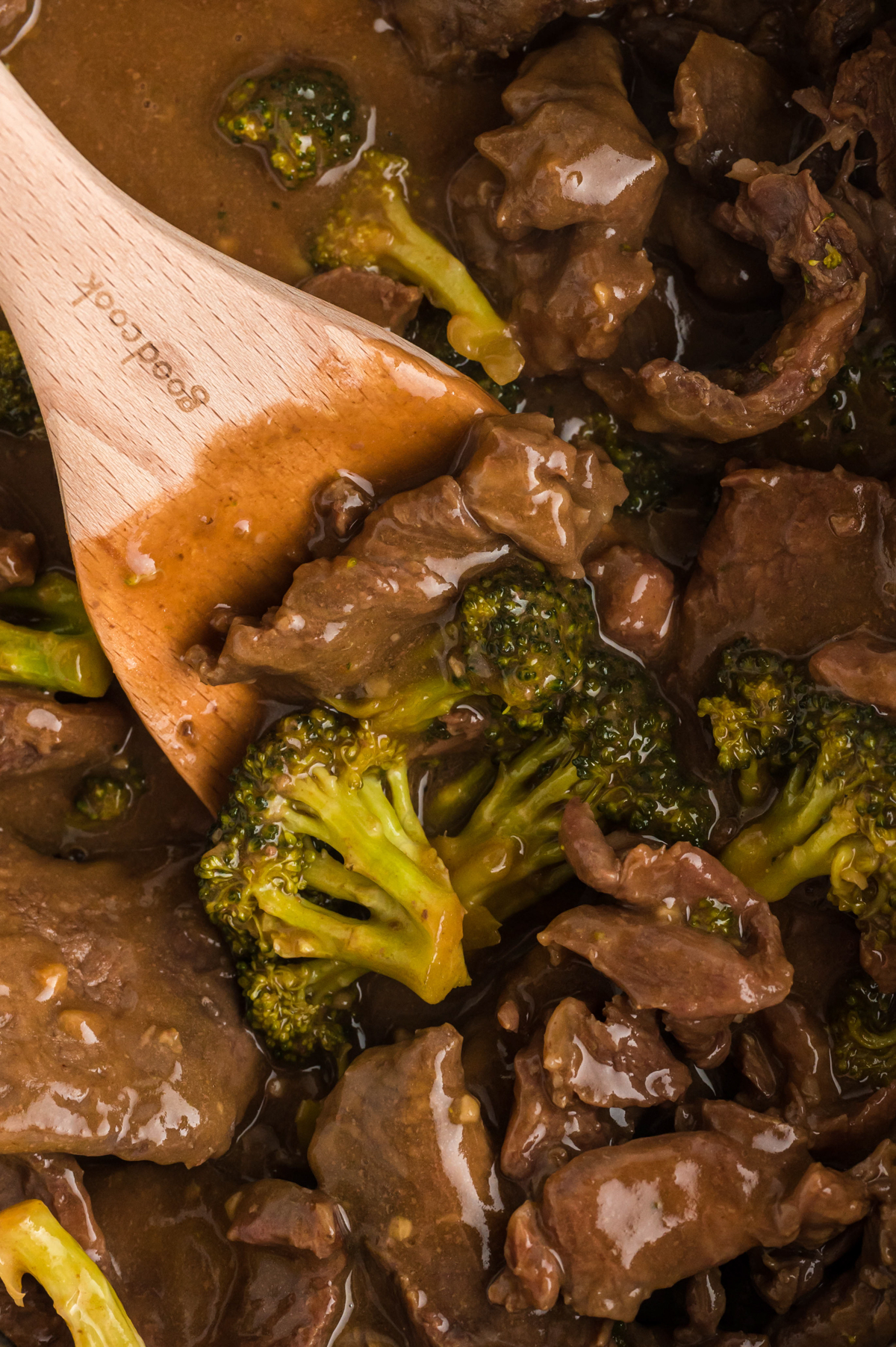 scooping out slow cooker beef and broccoli.