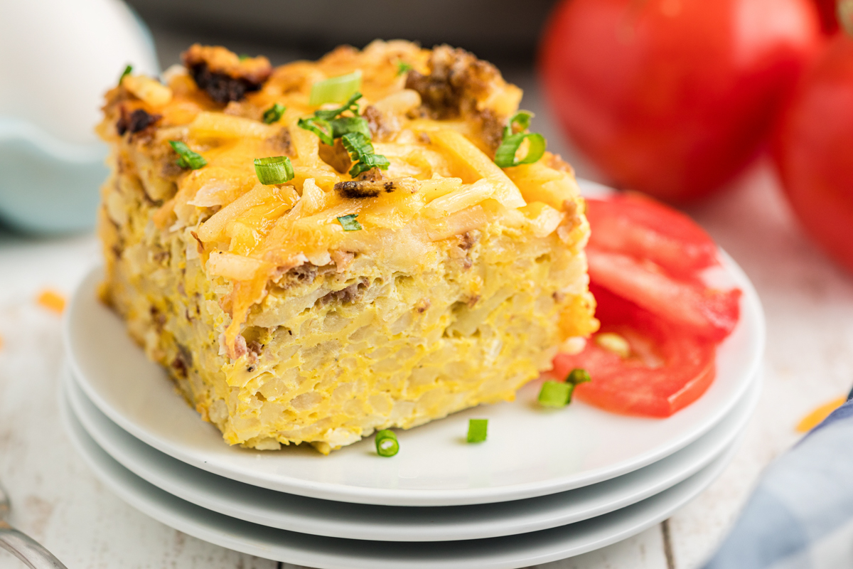 close-up shot of slow cooker breakfast casserole on a stack of plates.