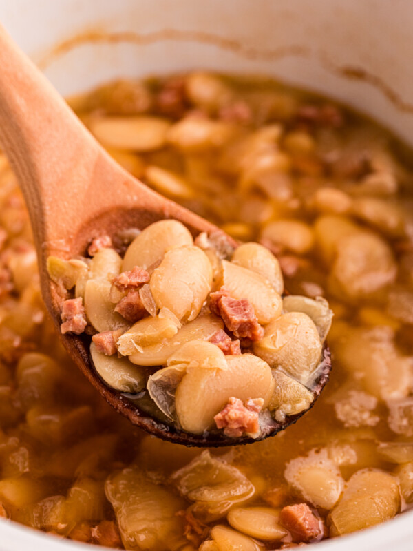 scooping lima beans out of a crockpot.