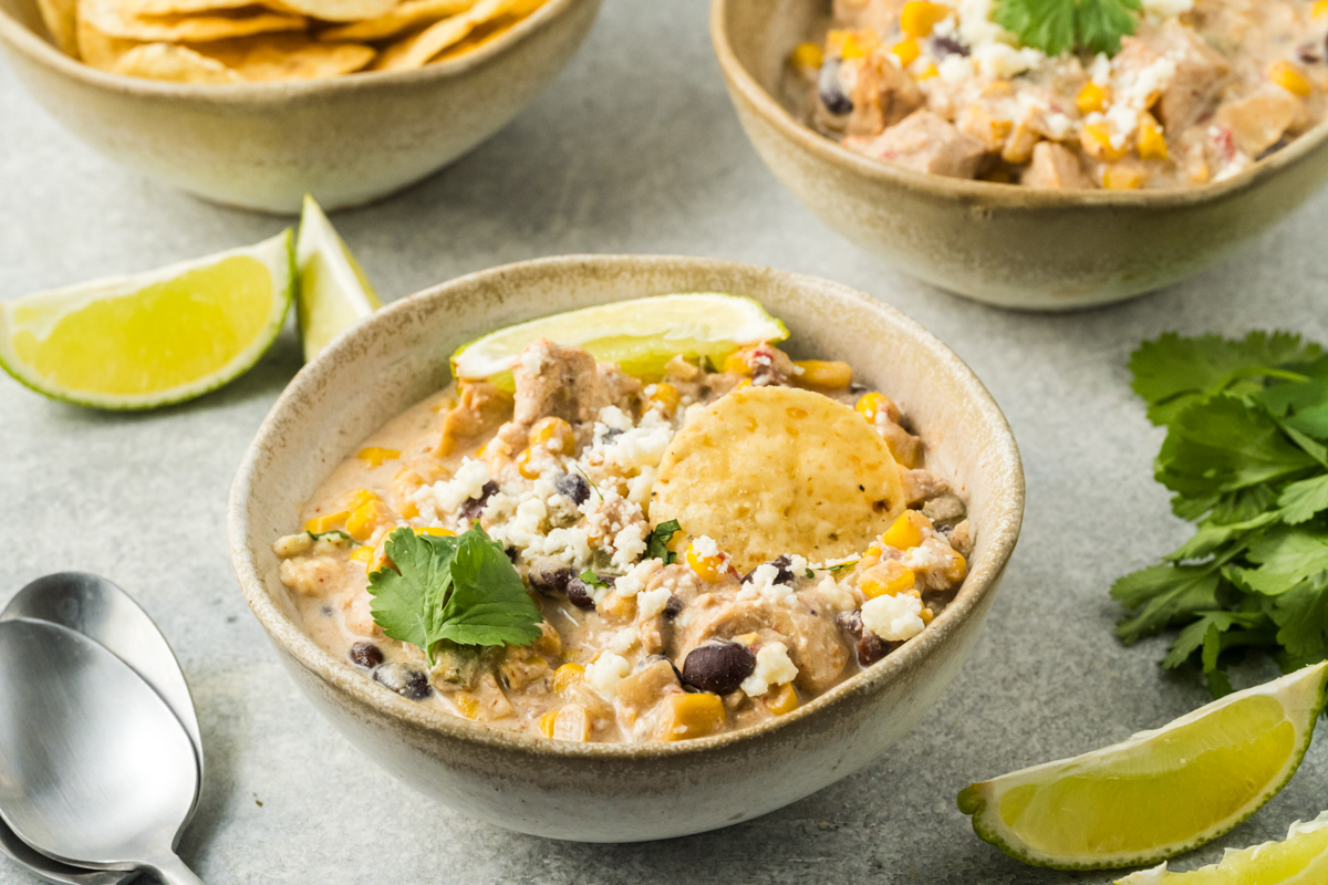 slow cooker street corn chicken in serving bowls.